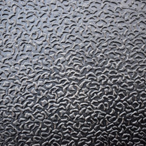 Amoebic rubber agricultural matting showing textured surface